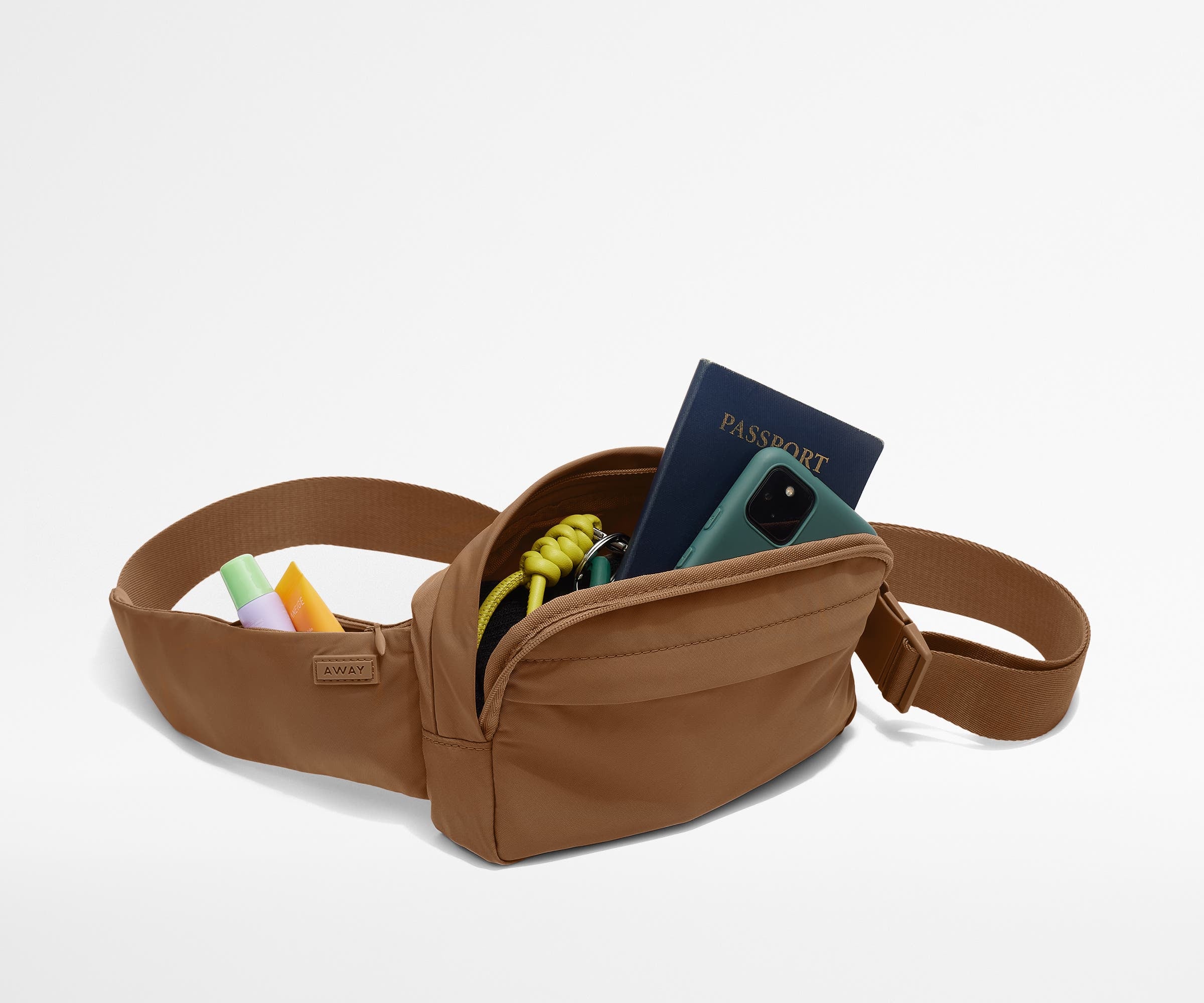 Sling Bag packed with a phone, passport, keys, and chapstick