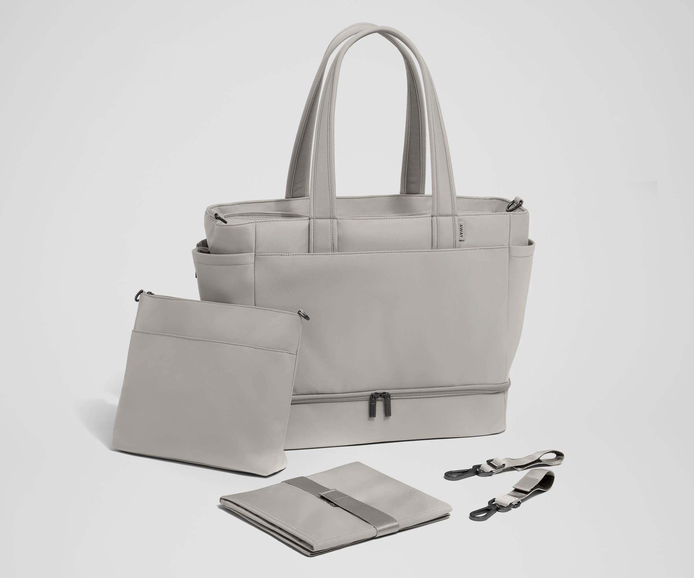 Tote with the included stroller clips, carry-all pouch, and changing pad